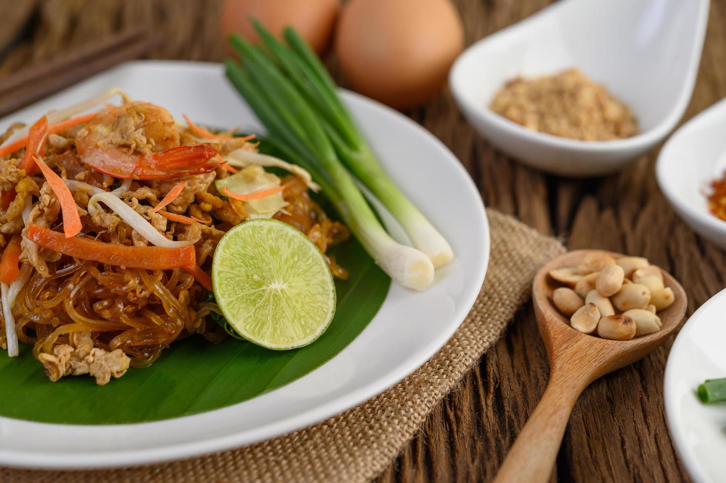 Plate of pad thai shrimp with lime and eggs photo