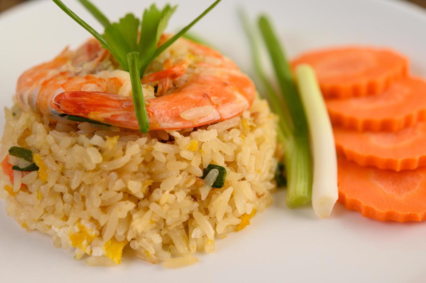 Arroz frito con camarones en un plato blanco foto