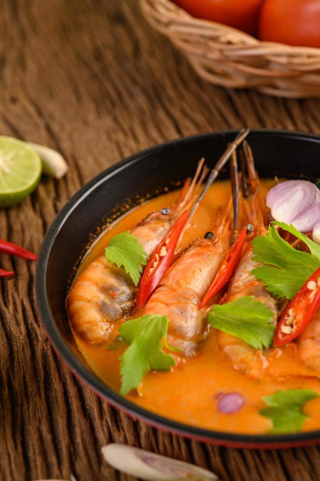 Thai hot spicy soup called tom yum kung with shrimp photo