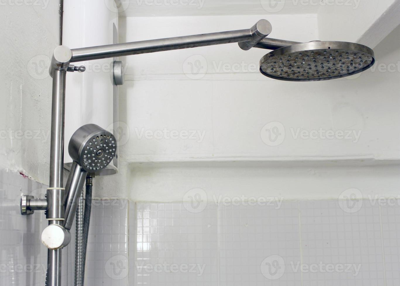 Bath shower on white tile wall photo