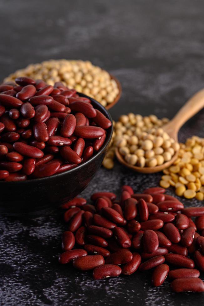 frijoles rojos en un cuenco de madera y una cuchara marrón foto