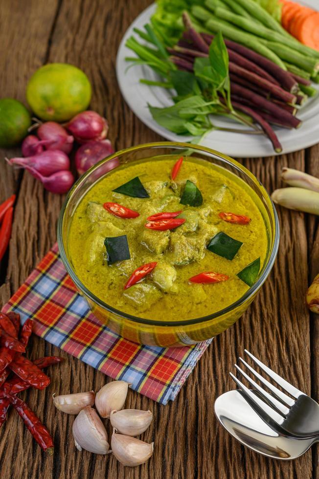 Green curry in a clear bowl photo
