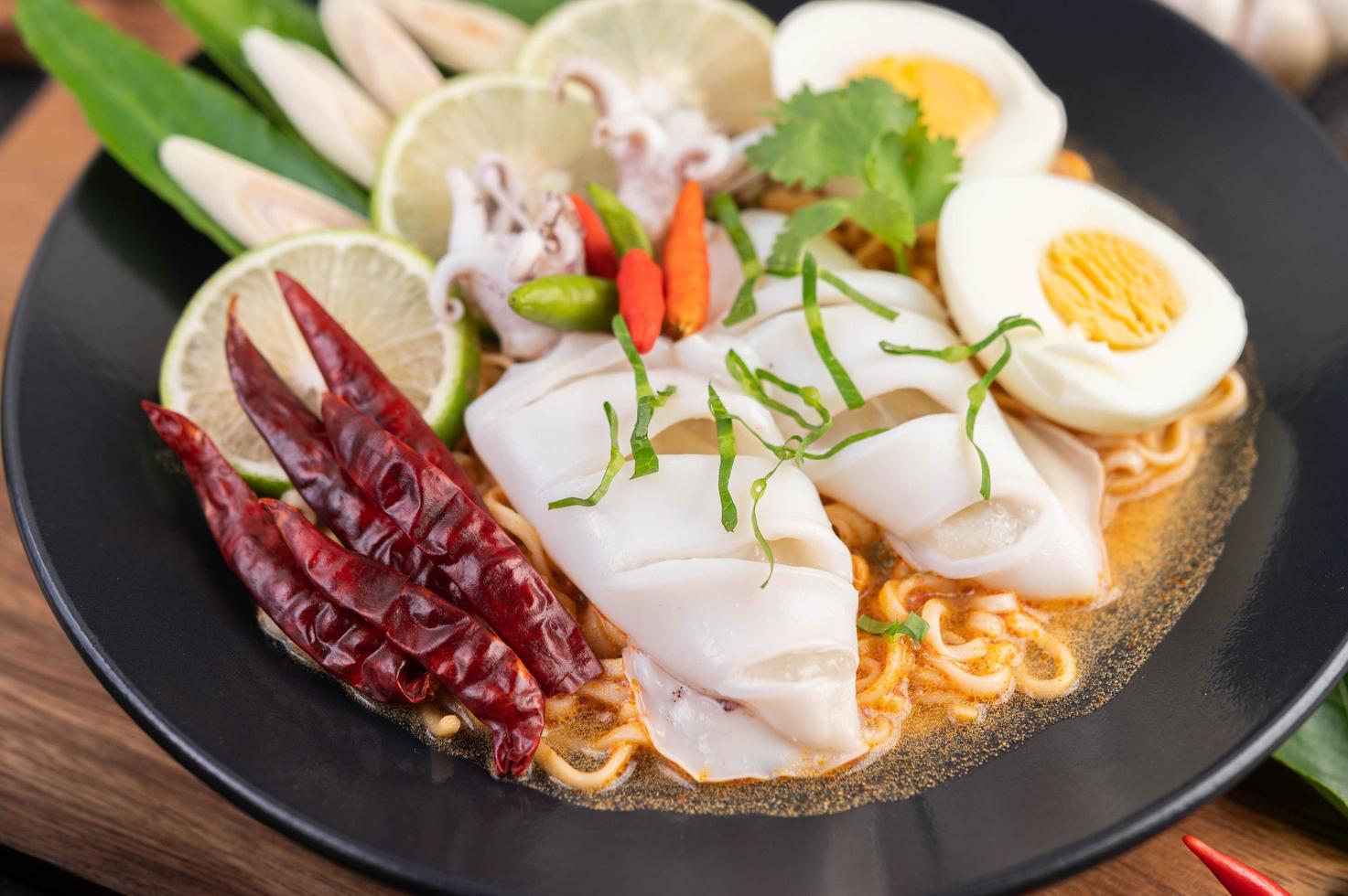 Noodles with squid and boiled egg photo