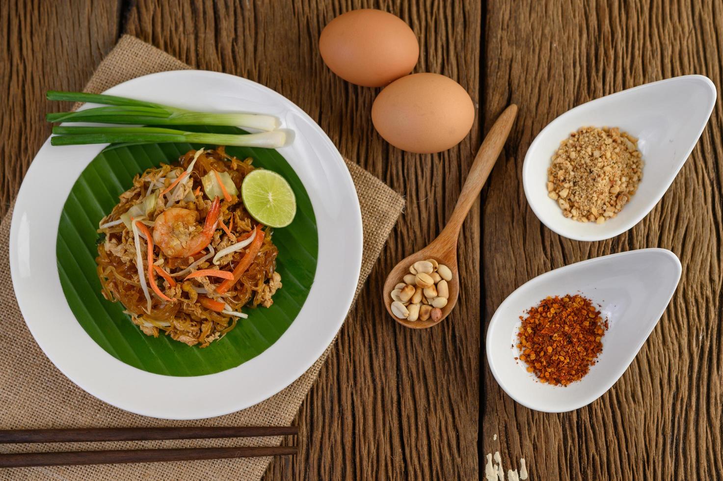 Plate of pad thai shrimp with lime and eggs photo