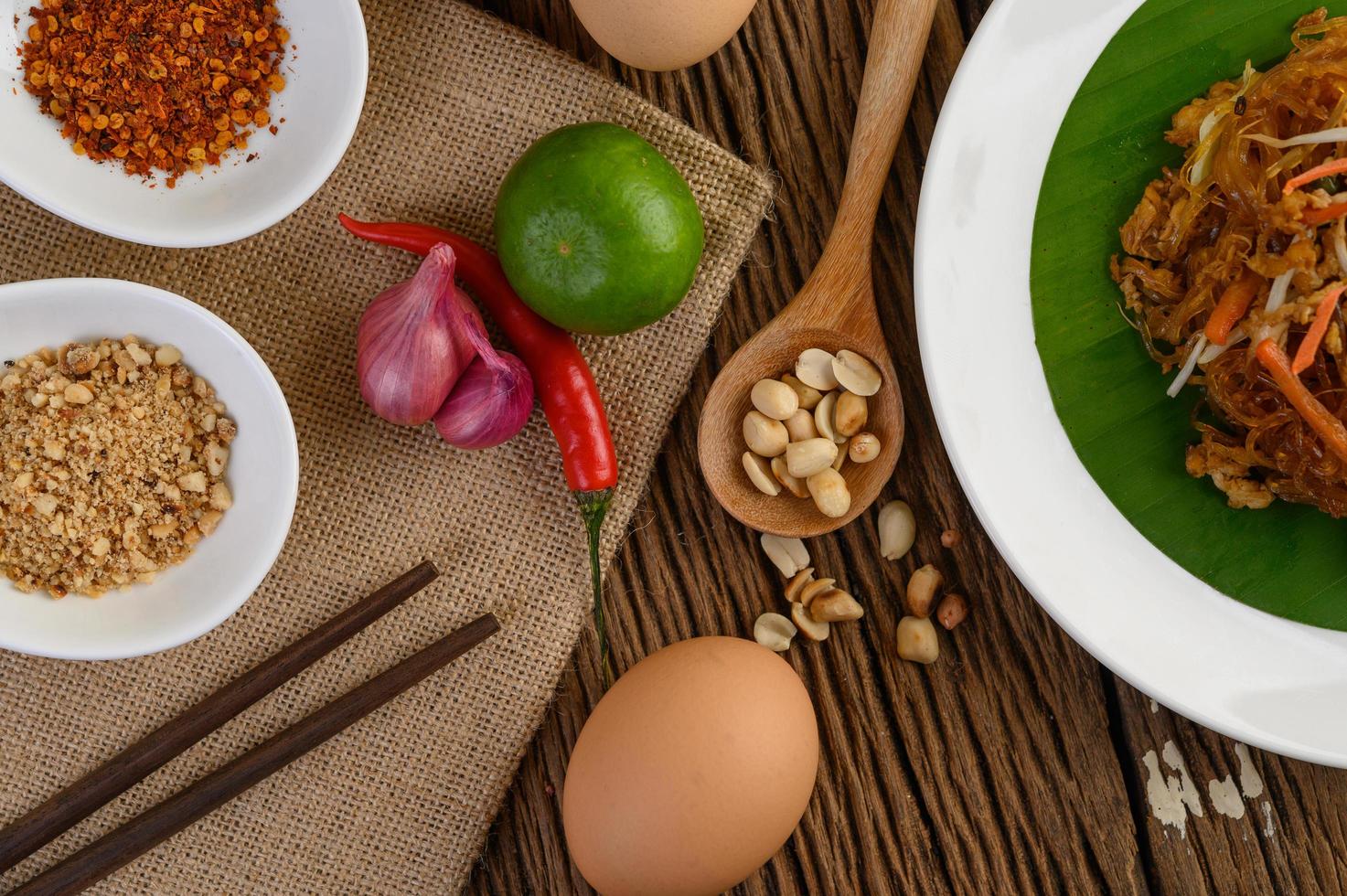 Plate of pad thai shrimp with lime and eggs photo