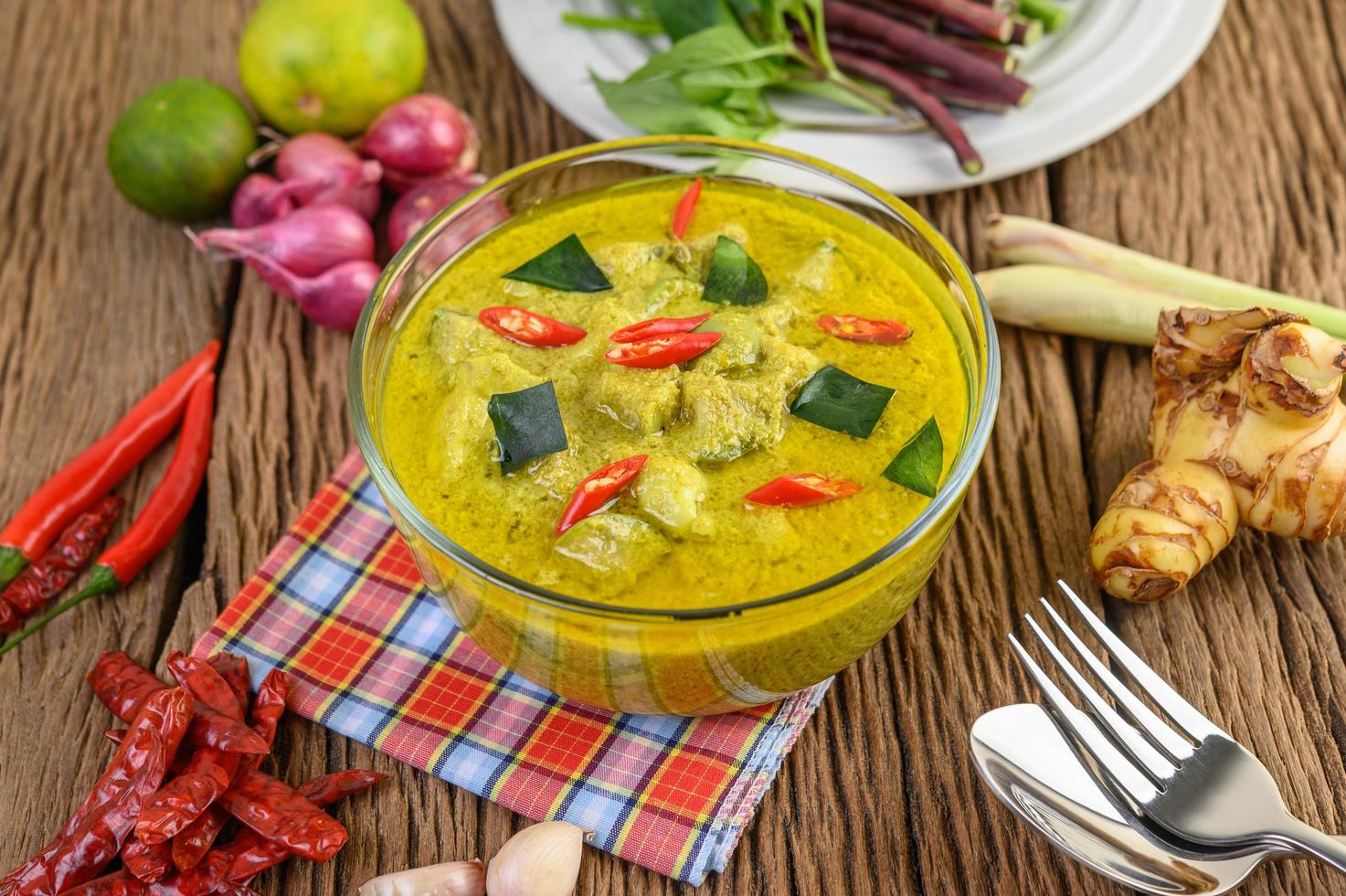 Green curry in a clear bowl photo