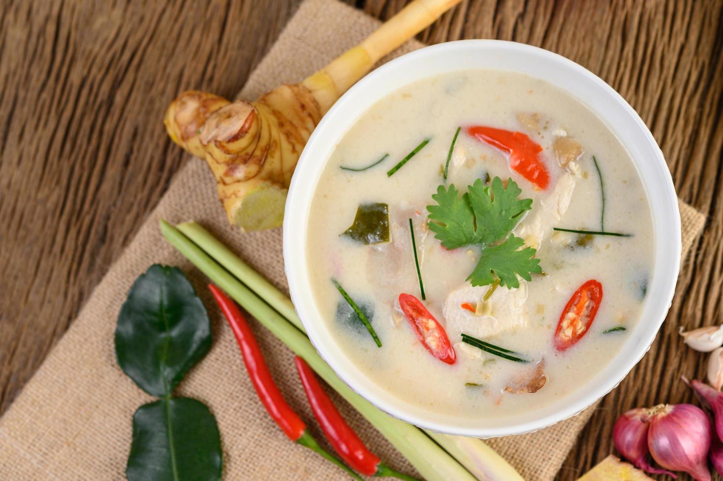 Tom Kha Kai, Thai coconut soup on wooden kitchen board photo