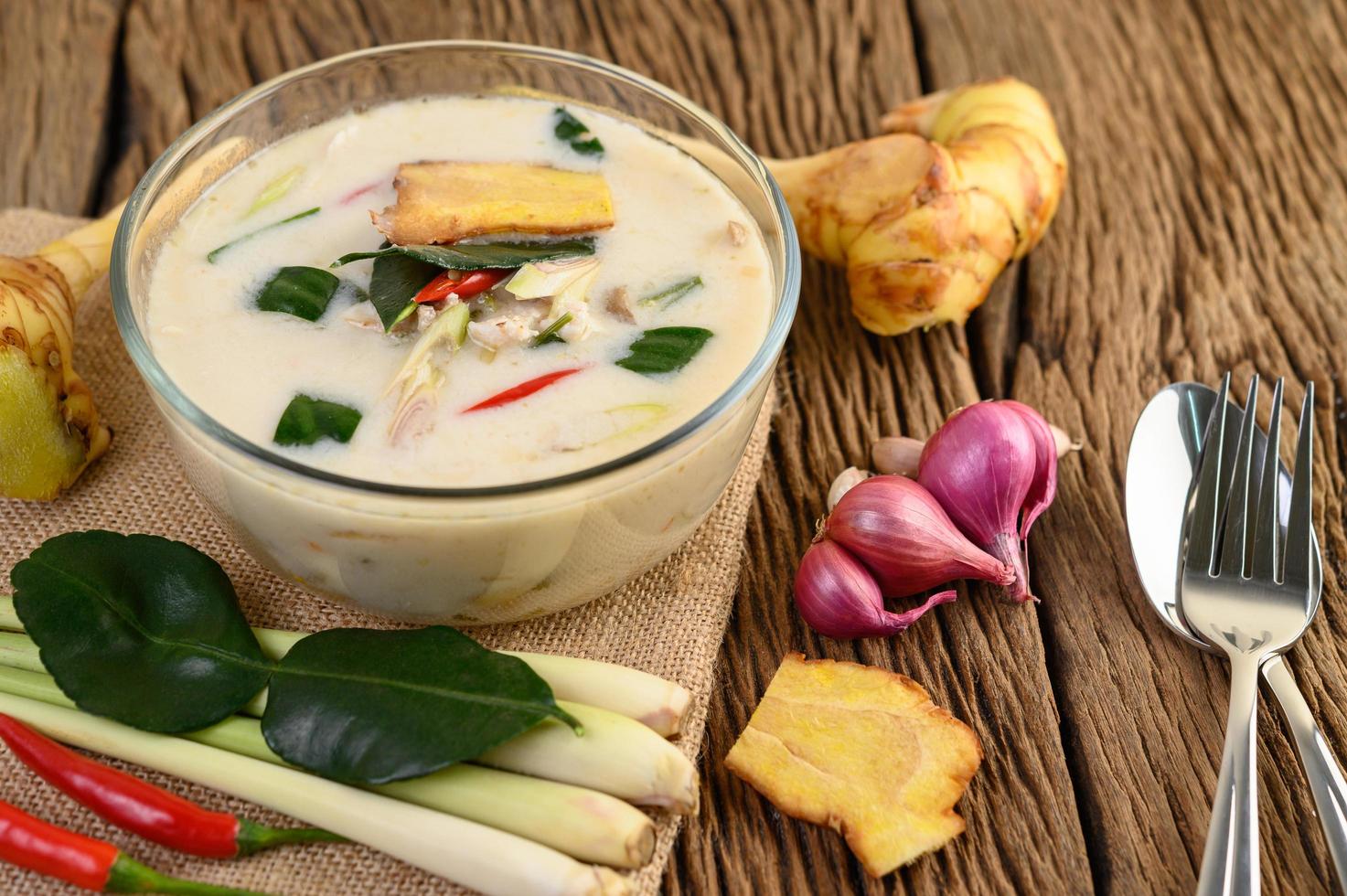 Tom Kha Kai, Thai coconut soup on wooden kitchen board photo