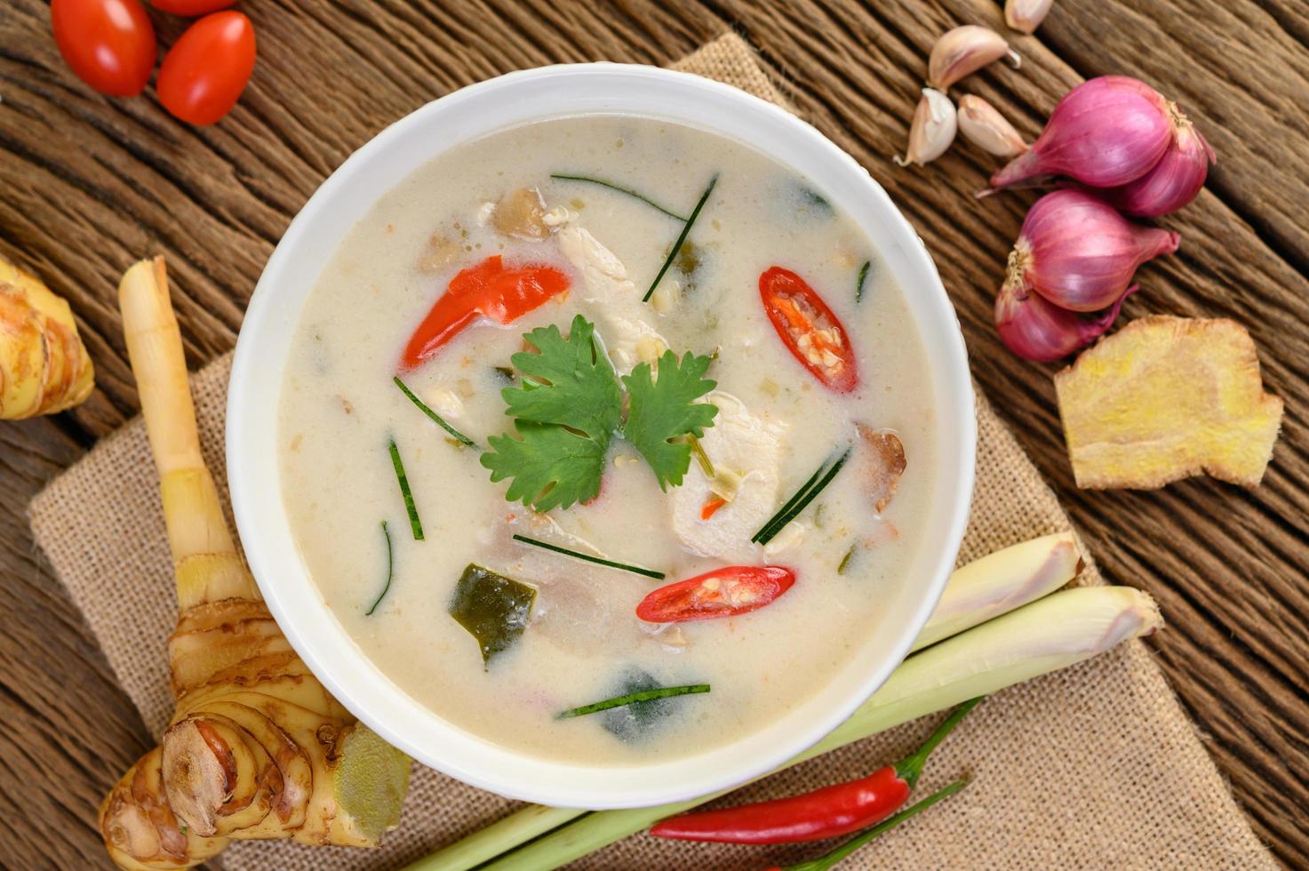 Tom Kha Kai, Thai coconut soup on wooden kitchen board photo