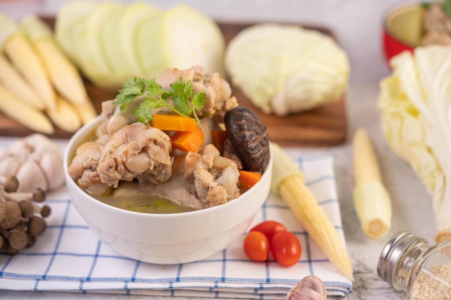 Pork meatball soup surrounded by ingredients photo