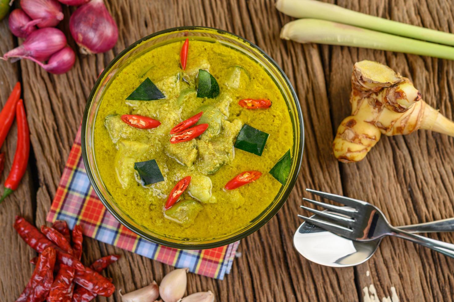 Green curry in a clear bowl photo