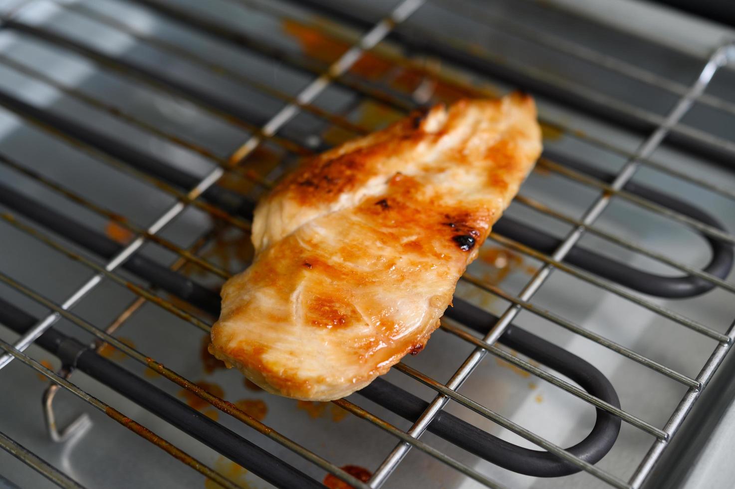 Grilled chicken on an electric grill photo