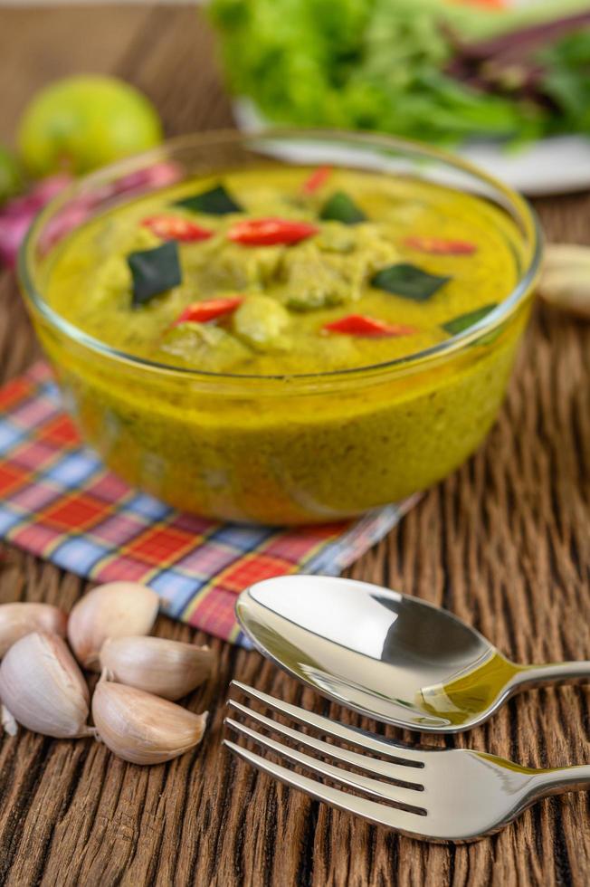 Green curry in a clear bowl photo