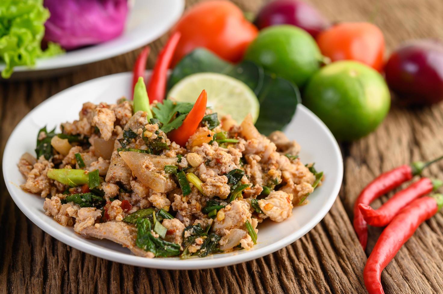 Minced pork salad with spices on a wooden table photo