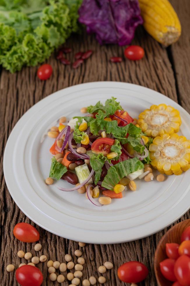 Fruit and vegetable salad on a white plate photo