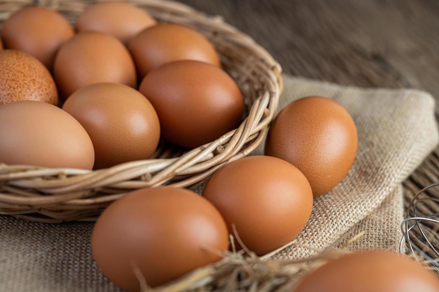 Raw eggs on hemp and straw photo