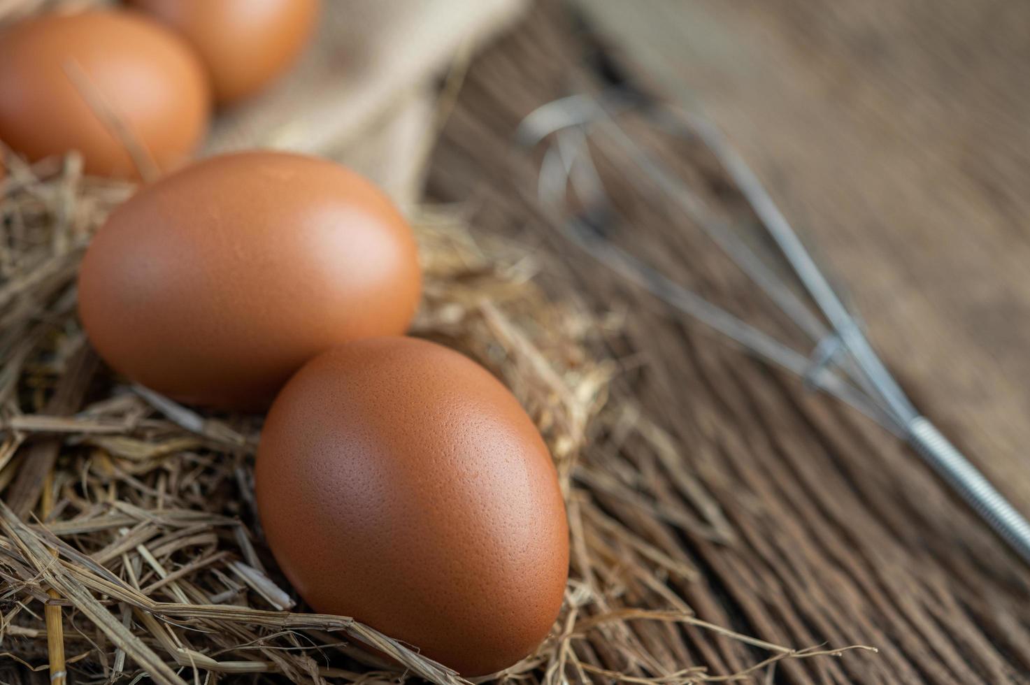 Raw eggs on hemp and straw photo