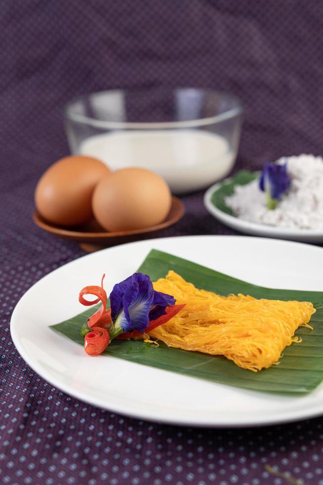 Fios de ovos dish of two eggs and coconut milk photo