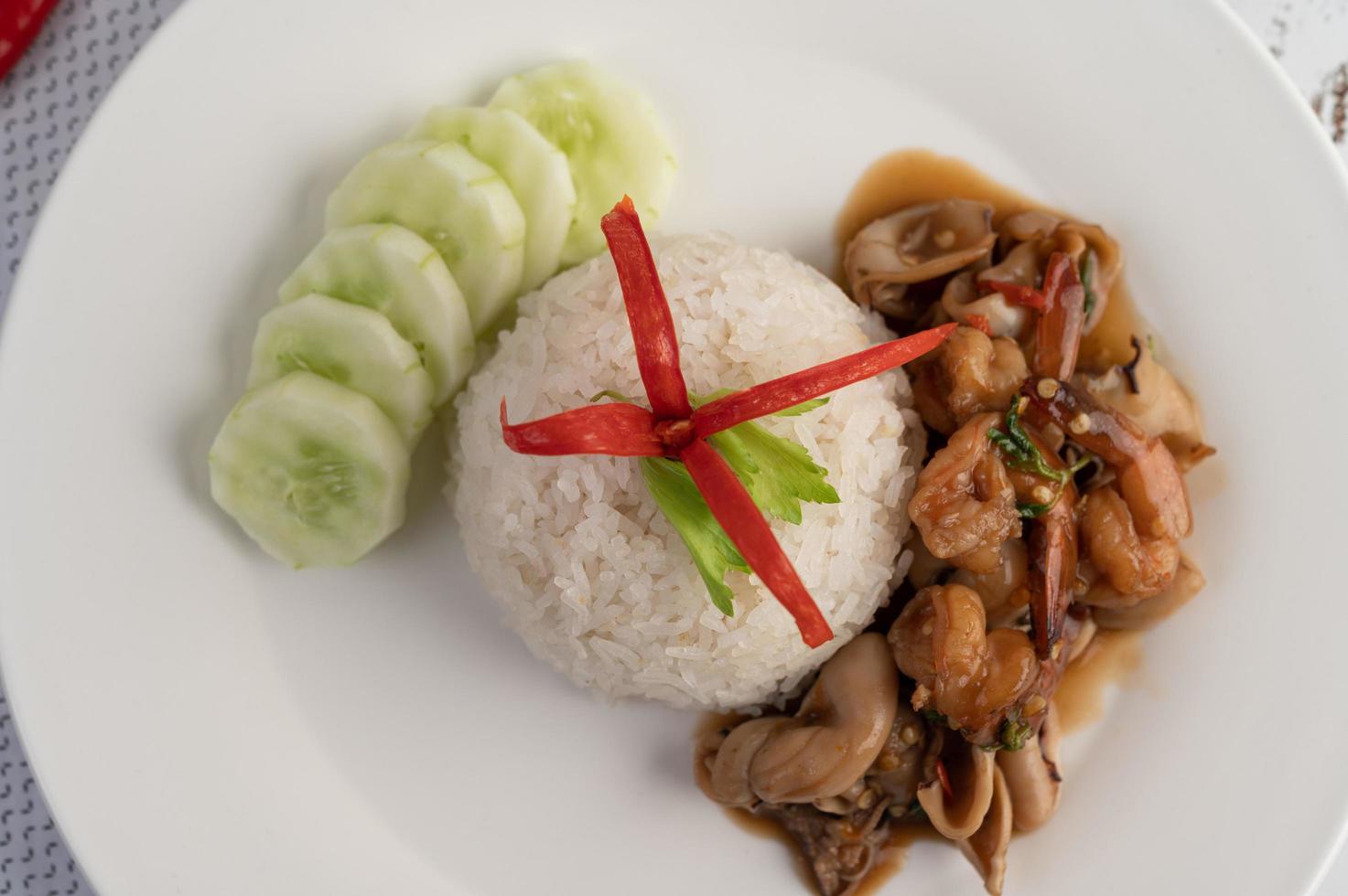 Rice topped with stir-fried basil with squid and shrimp photo