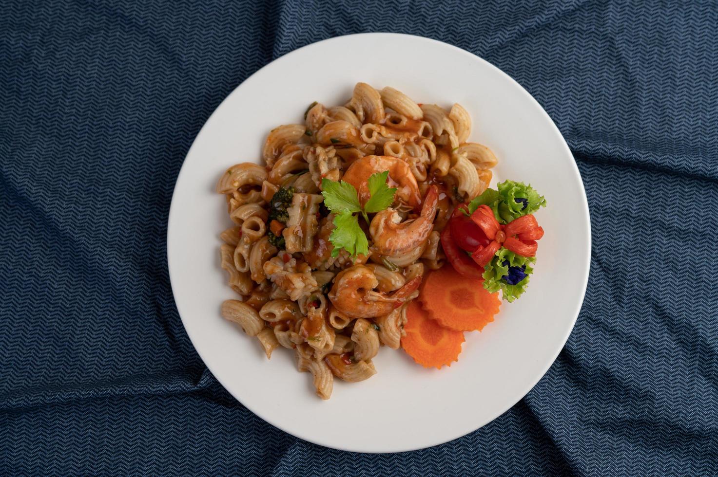 Shrimp and macaroni with carrots, tomatoes and salad photo