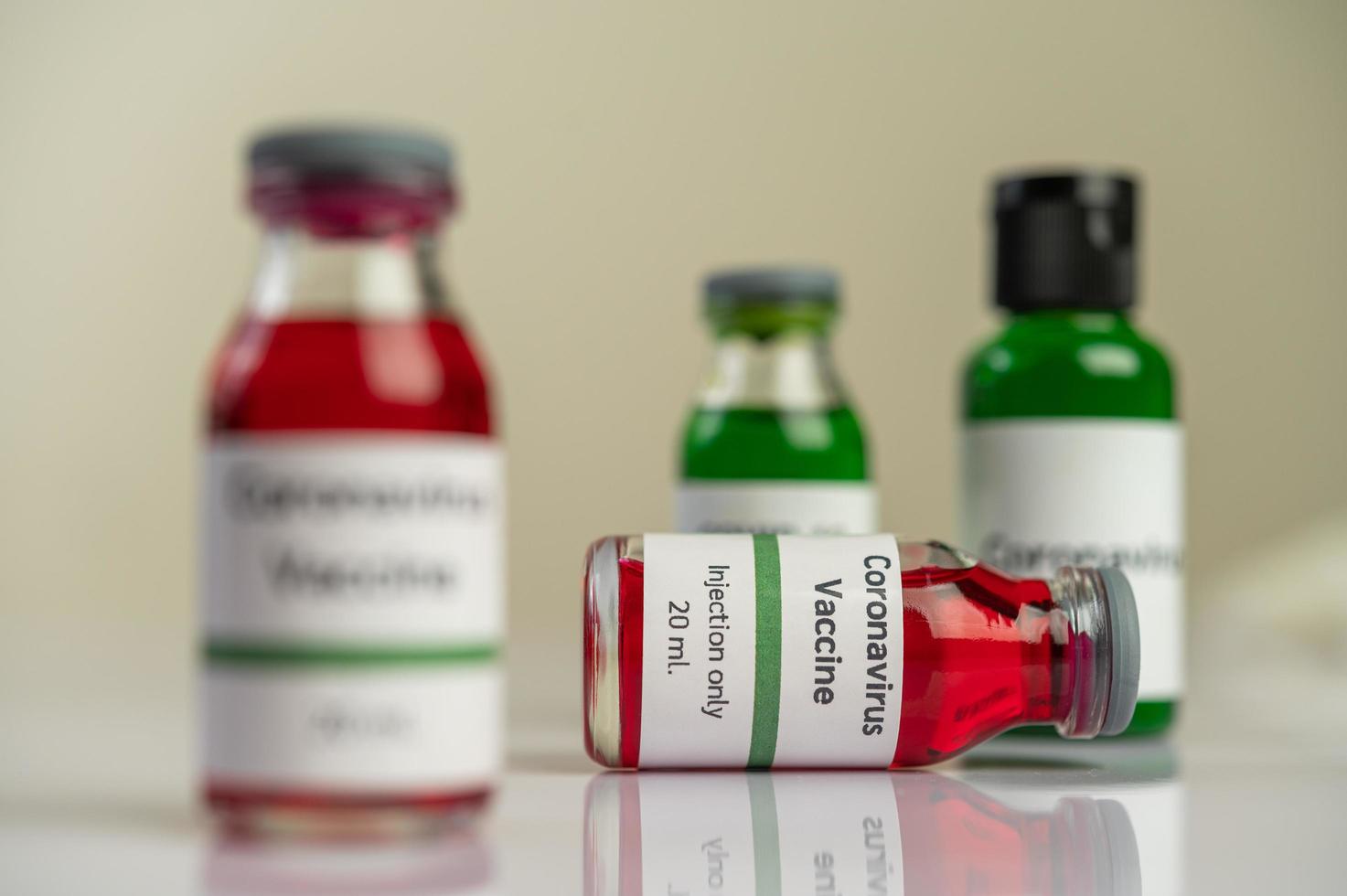 The vaccine against covid-19 in red and green bottles photo