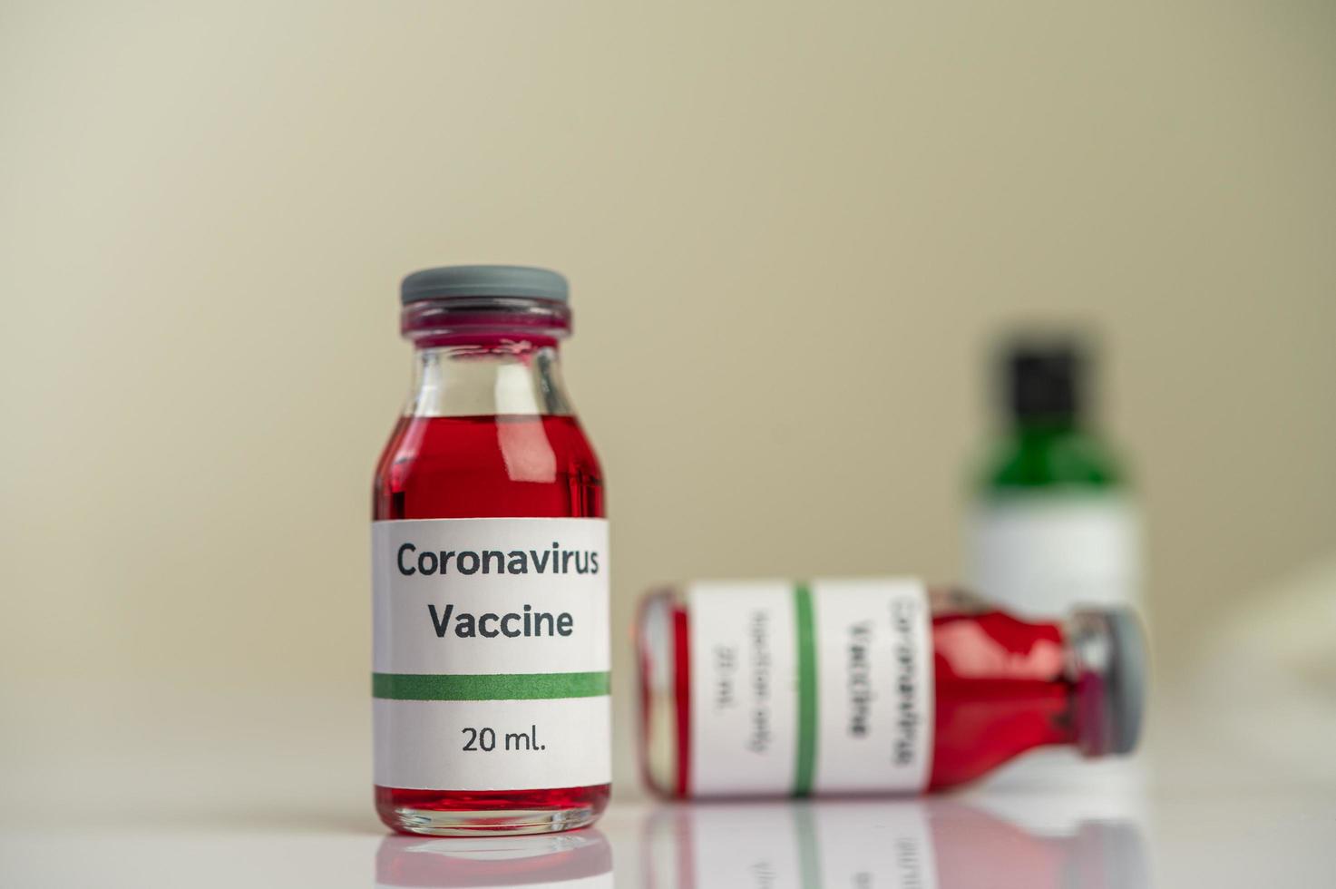 The vaccine against covid-19 in red and green bottles photo