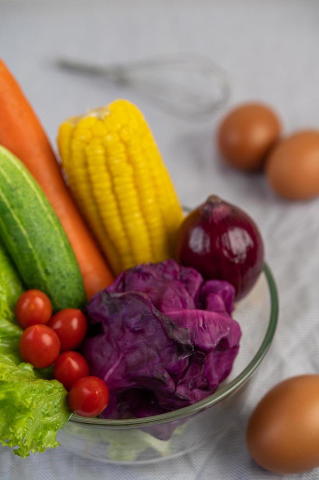 Tomatoes, carrots, cucumbers, onions, eggs and purple cabbage photo