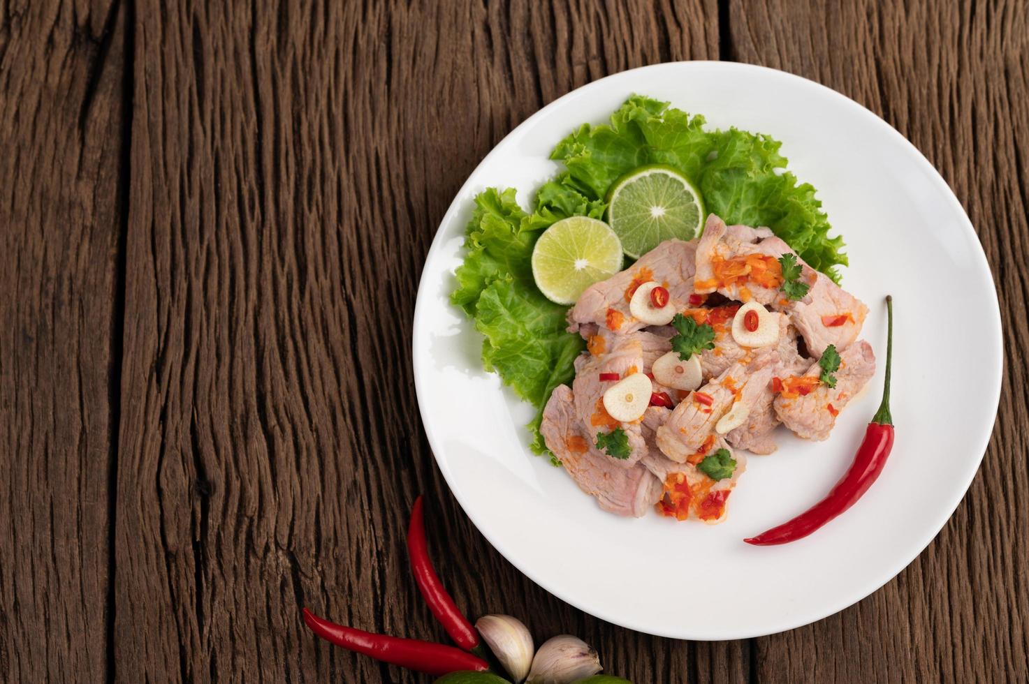 Spicy lime pork with salad photo