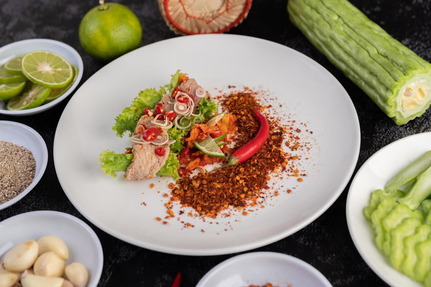 Spicy pork salad with galangal, lemon, chili and garlic photo