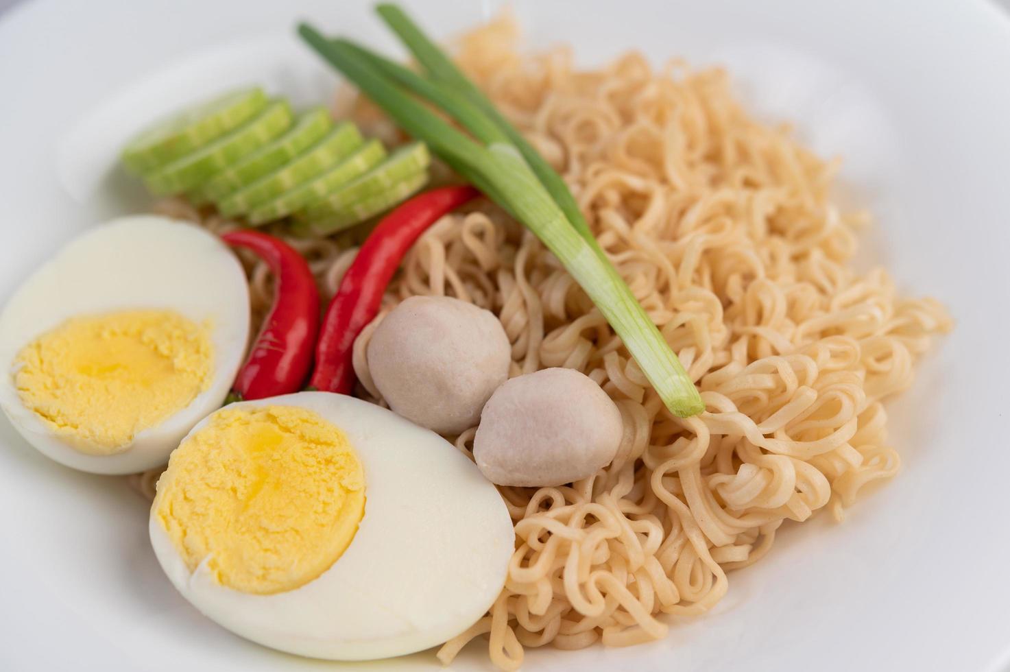 Noodles with boiled eggs and vegetables photo