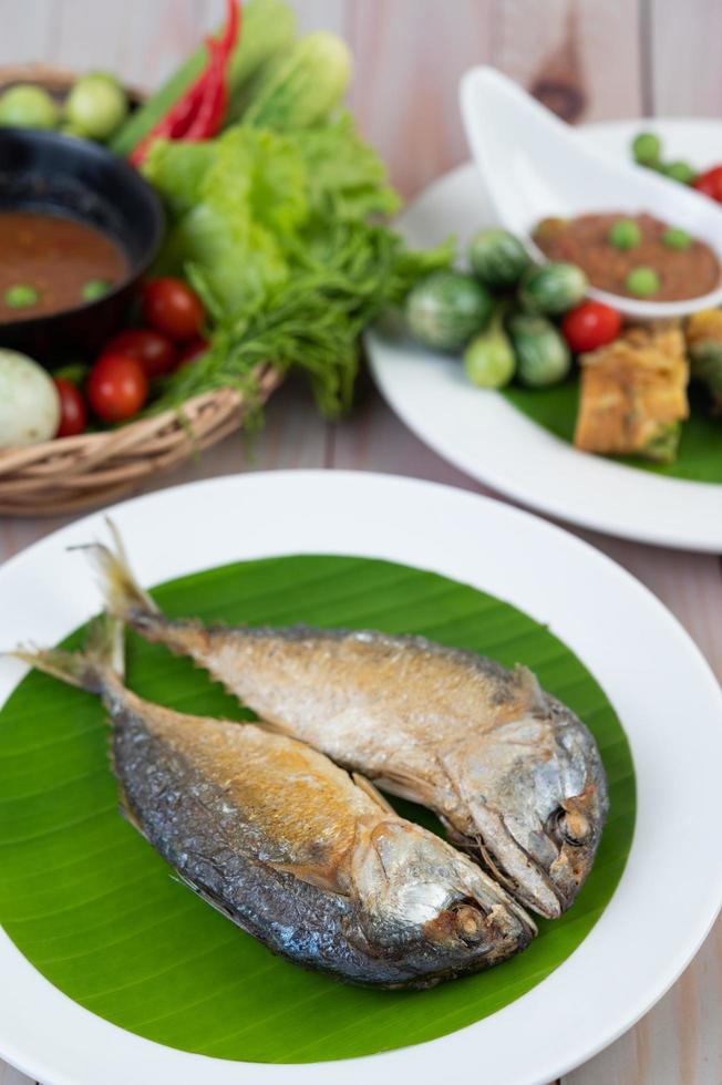 Fried mackerel on a white plate photo