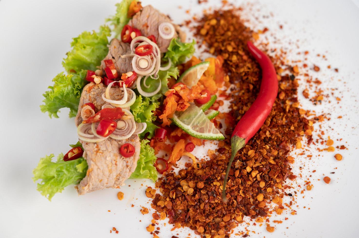 Spicy pork salad with galangal, lemon, chili and garlic photo