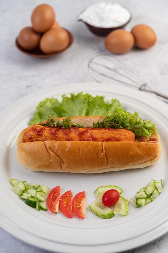 Sausage in bread and lettuce topped with sauce and eggs with flour photo