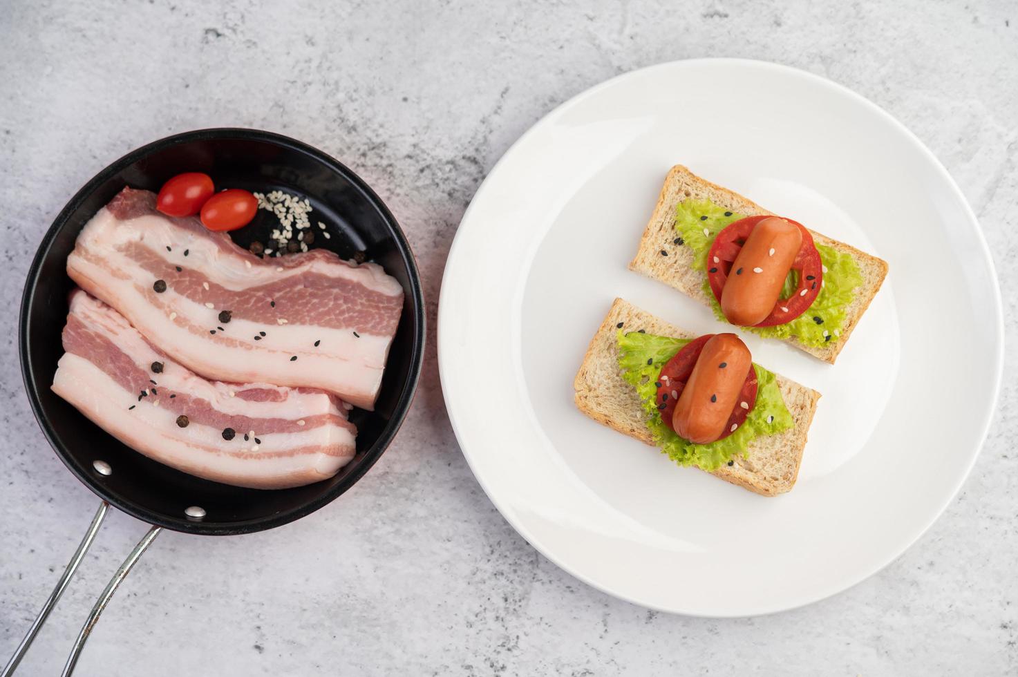 Pork belly in a pan with pepper seeds, tomatoes and spices photo