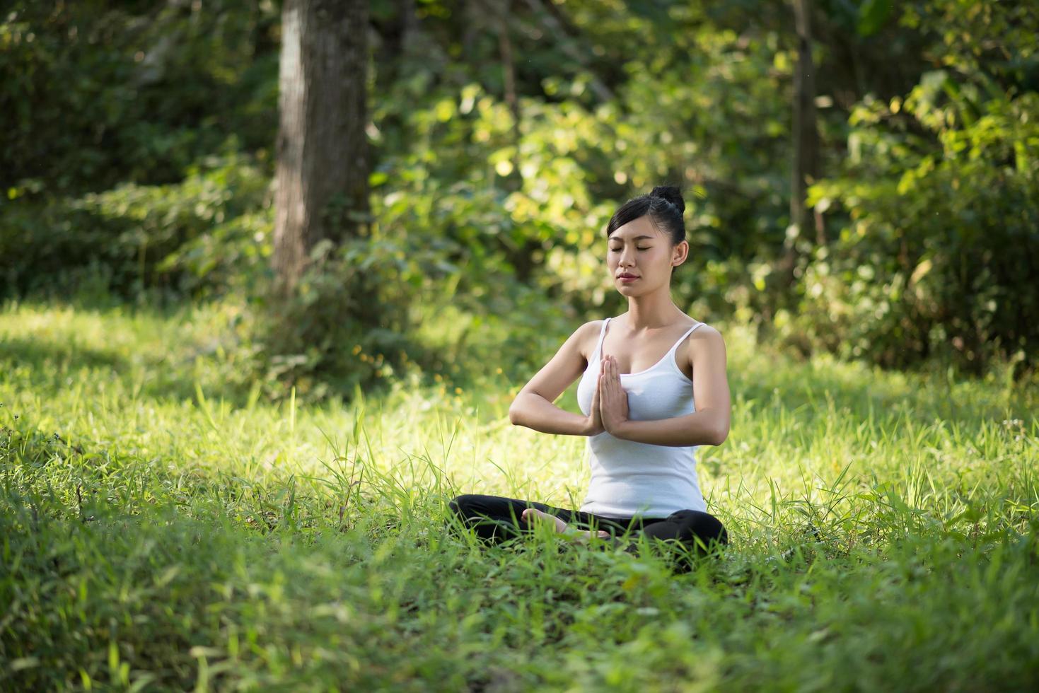 Woman in yoga pose outdoors in nature photo