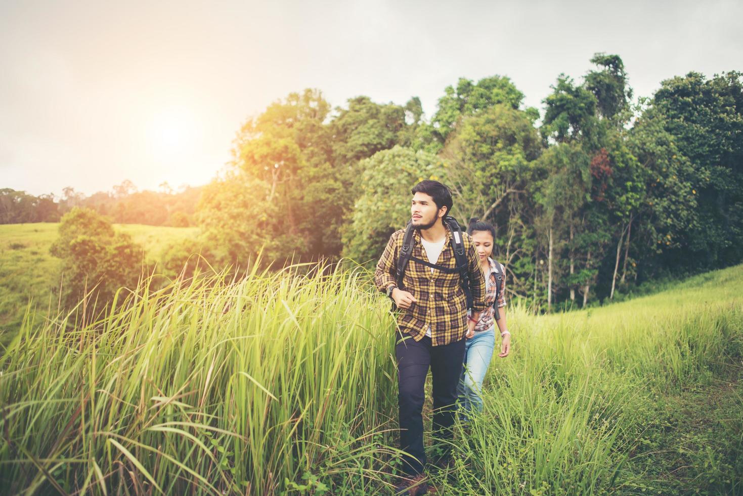 Portrait of a happy young couple walking on a hiking trip photo