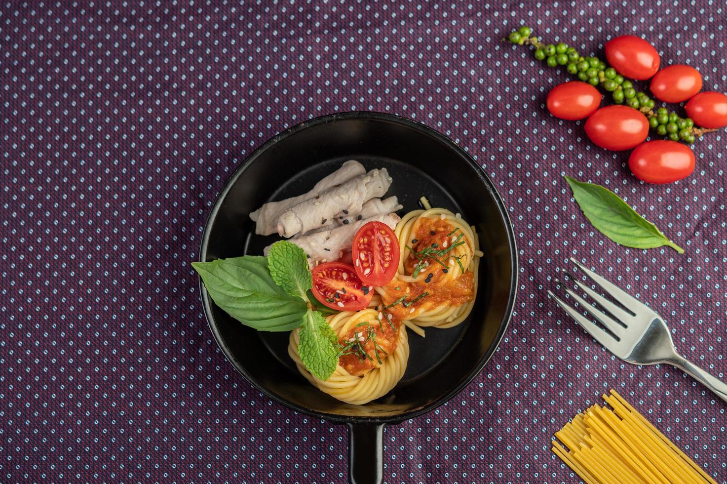 Spiced spaghetti in a frying pan photo