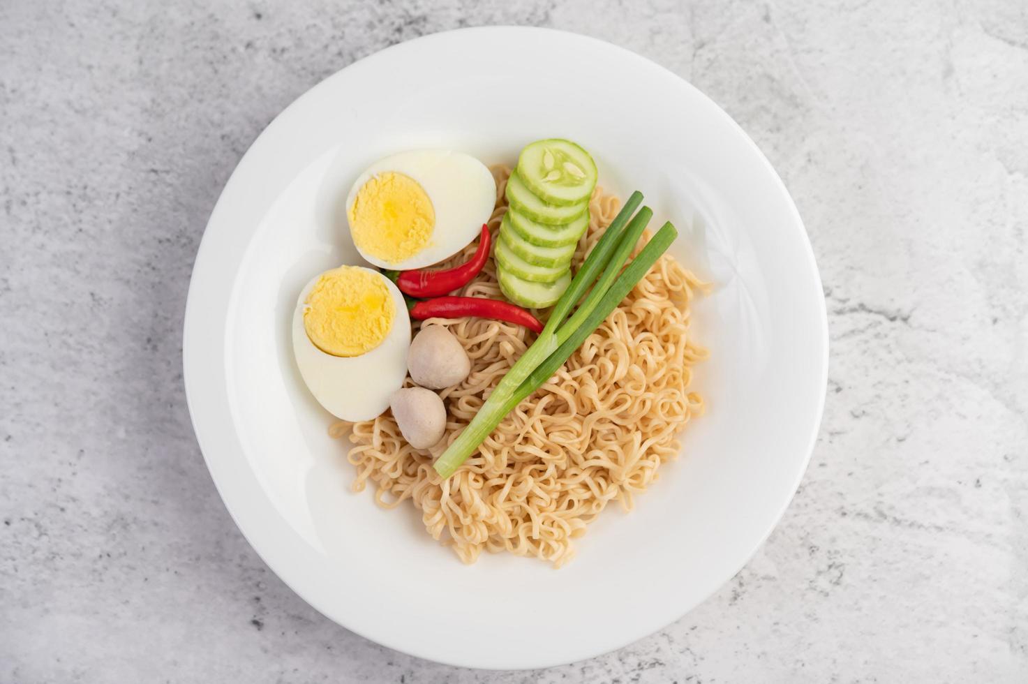 Noodles with boiled eggs and vegetables photo