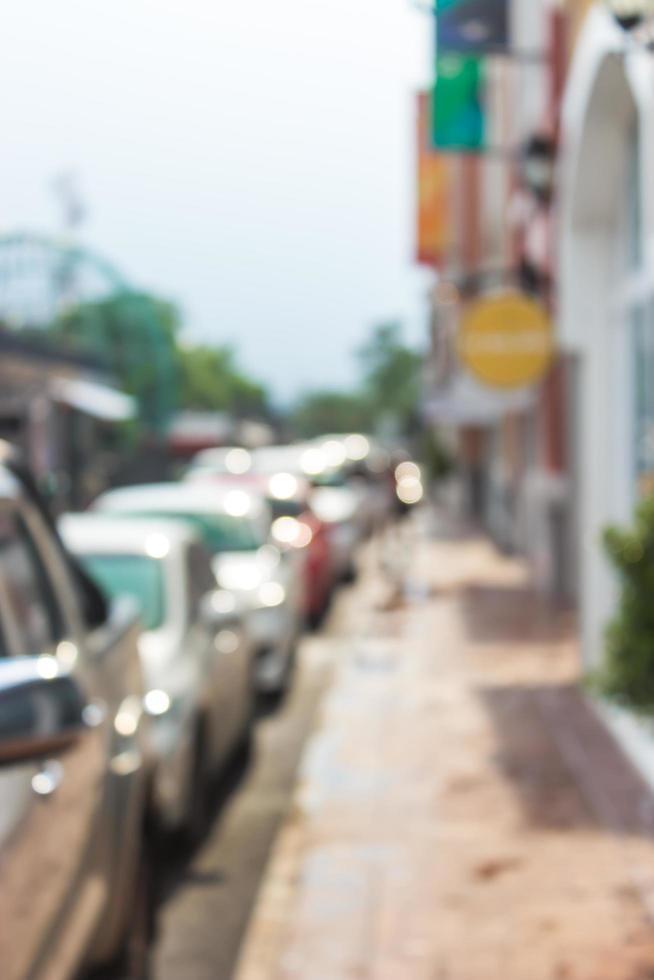 Blurred sidewalk and cars photo