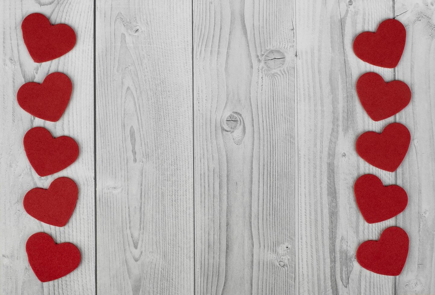 Line of red hearts on the sides of a white and grey wooden background. concept of valentine's day photo