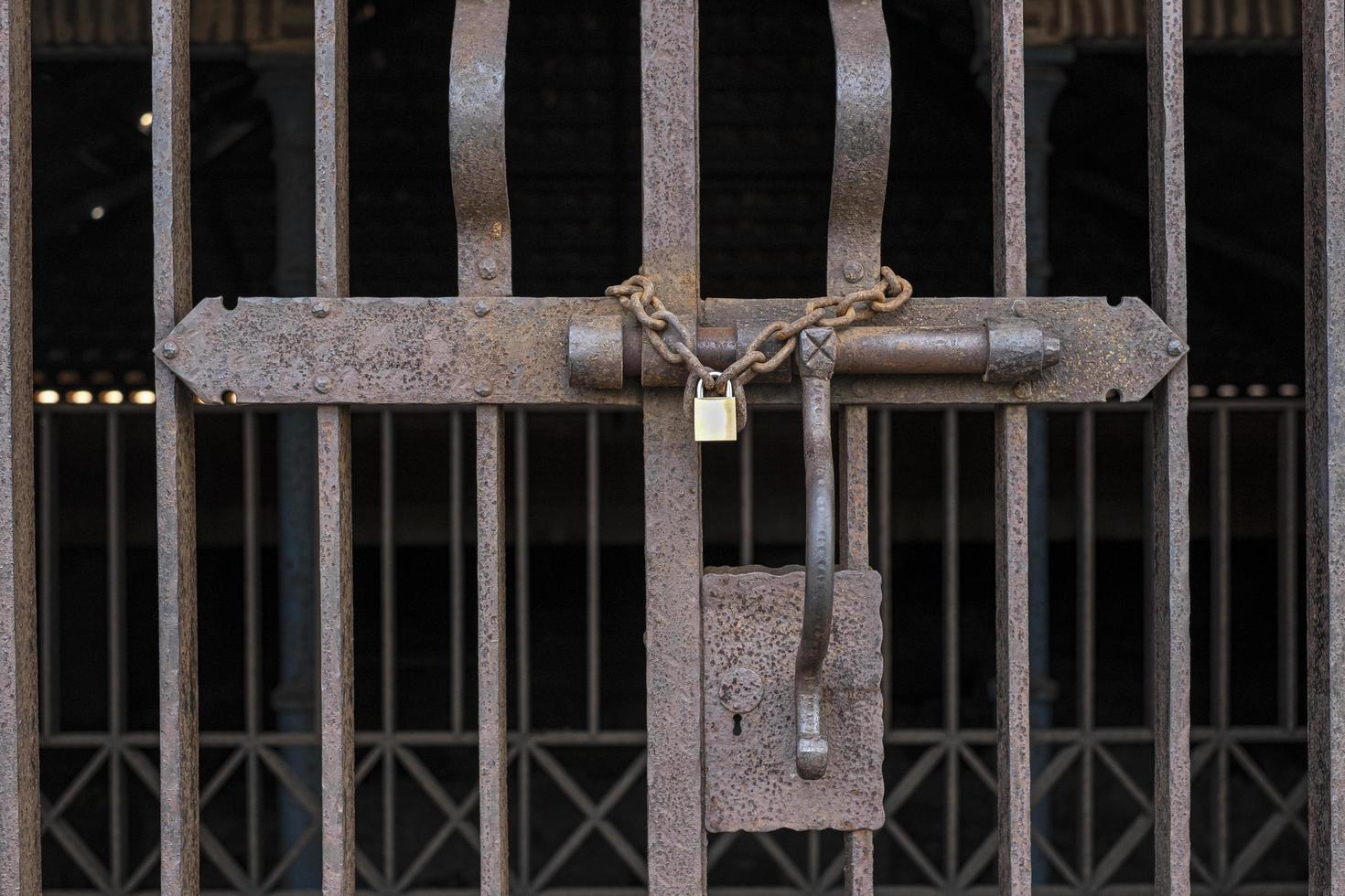 Rrusty lock with a padlock closing a gate photo