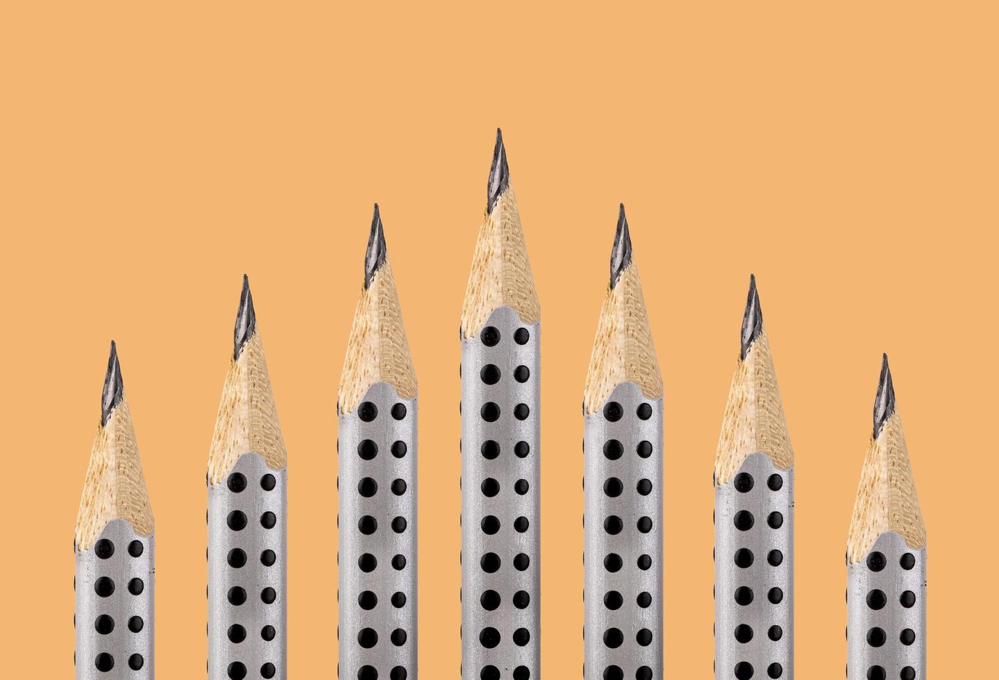 Graphite pencils with the fine tip on an ocher background photo