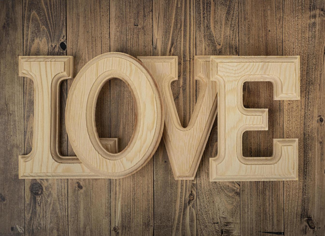 Wooden letters forming the word love on a walnut wood background. Concept of St. Valentine's Day photo