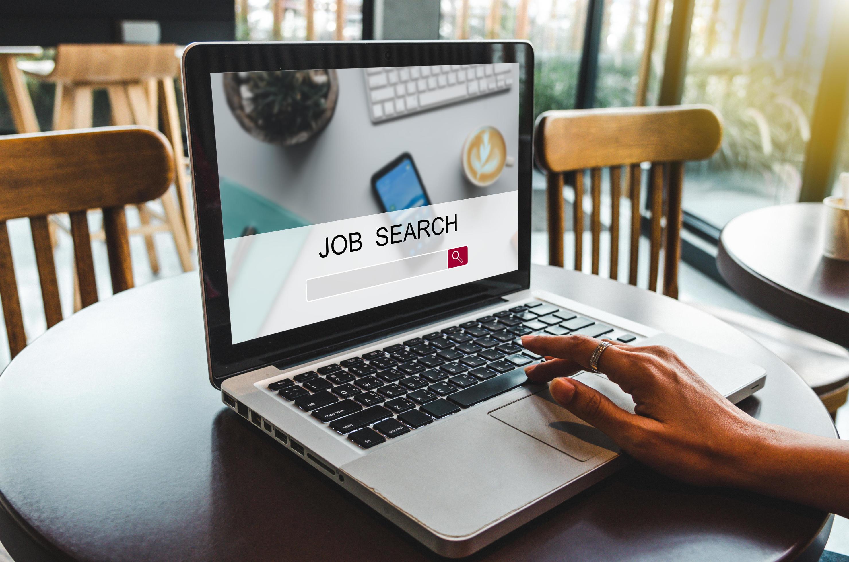 Professional woman searching for federal job opportunities online in Kansas