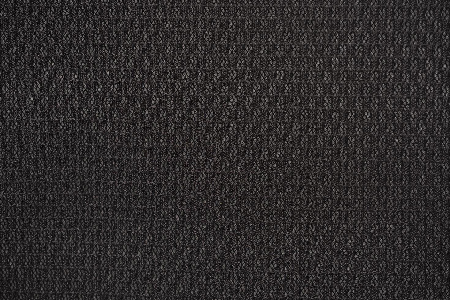 Black nylon fabric textured background with hexagonal shape photo