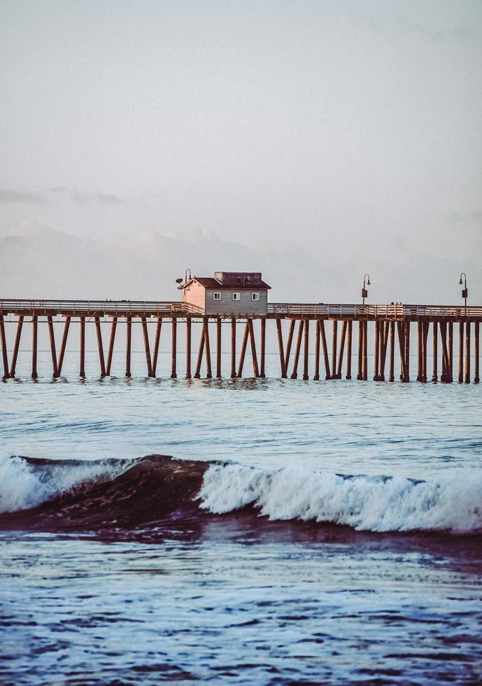 Brown wooden dock on sea during daytime photo