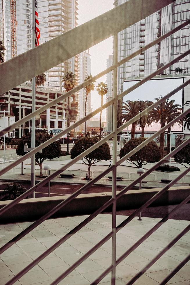 Green palm trees near white concrete building during daytime photo