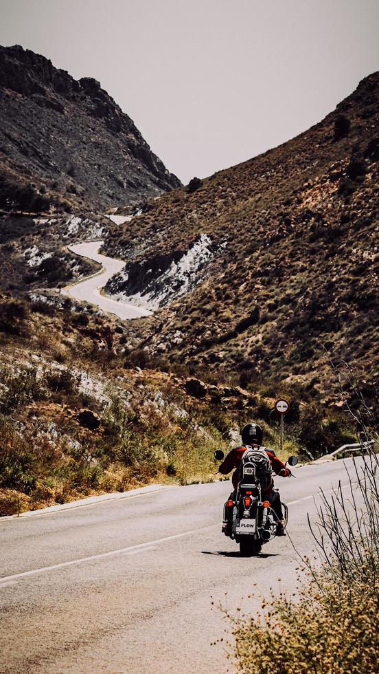 Costa Blanca, Spain, 2020 - Man in red jacket riding motorcycle on road during daytime photo