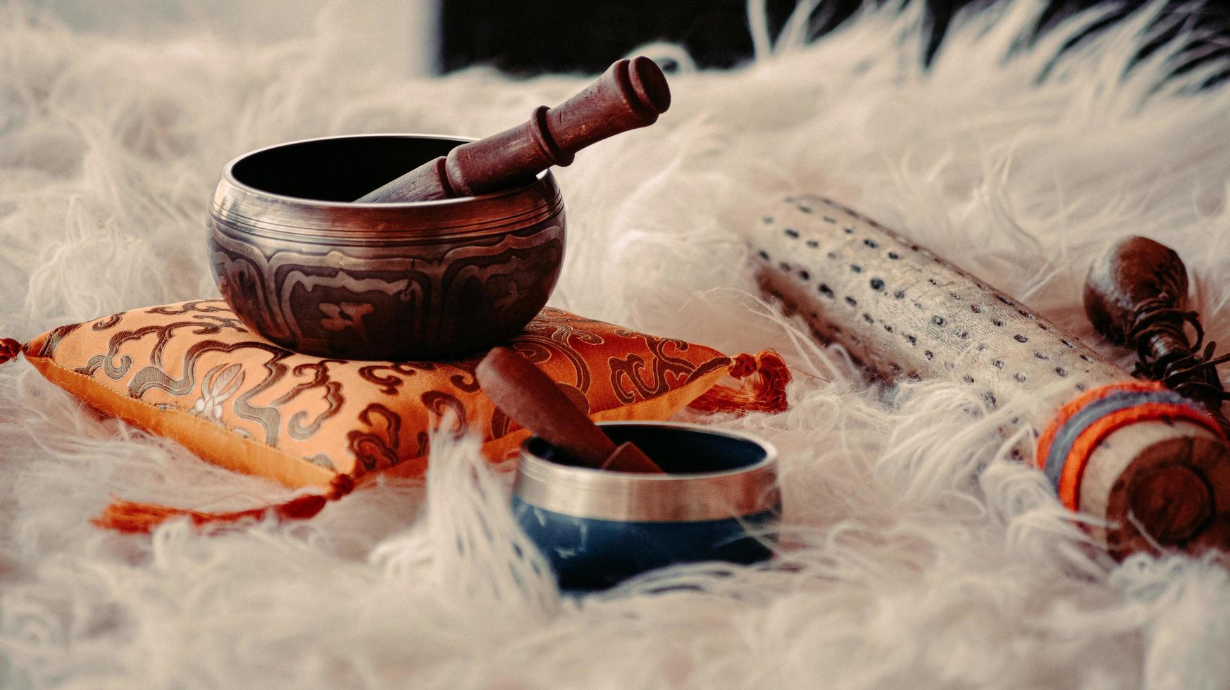 Brown wooden mortar and pestle on white textile photo