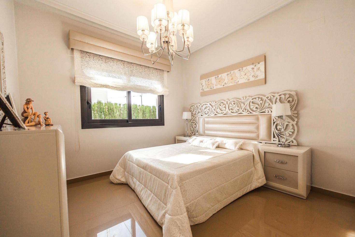 Costa Blanca, Spain, 2020 - White bed comforter near glass window photo
